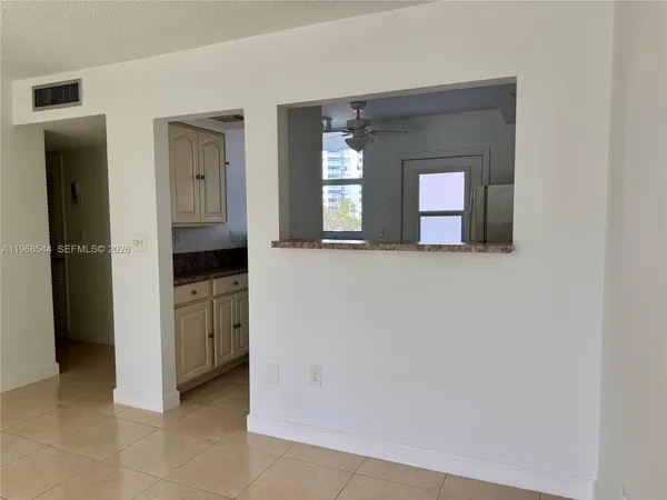 a view of a hallway with bathroom and mirror