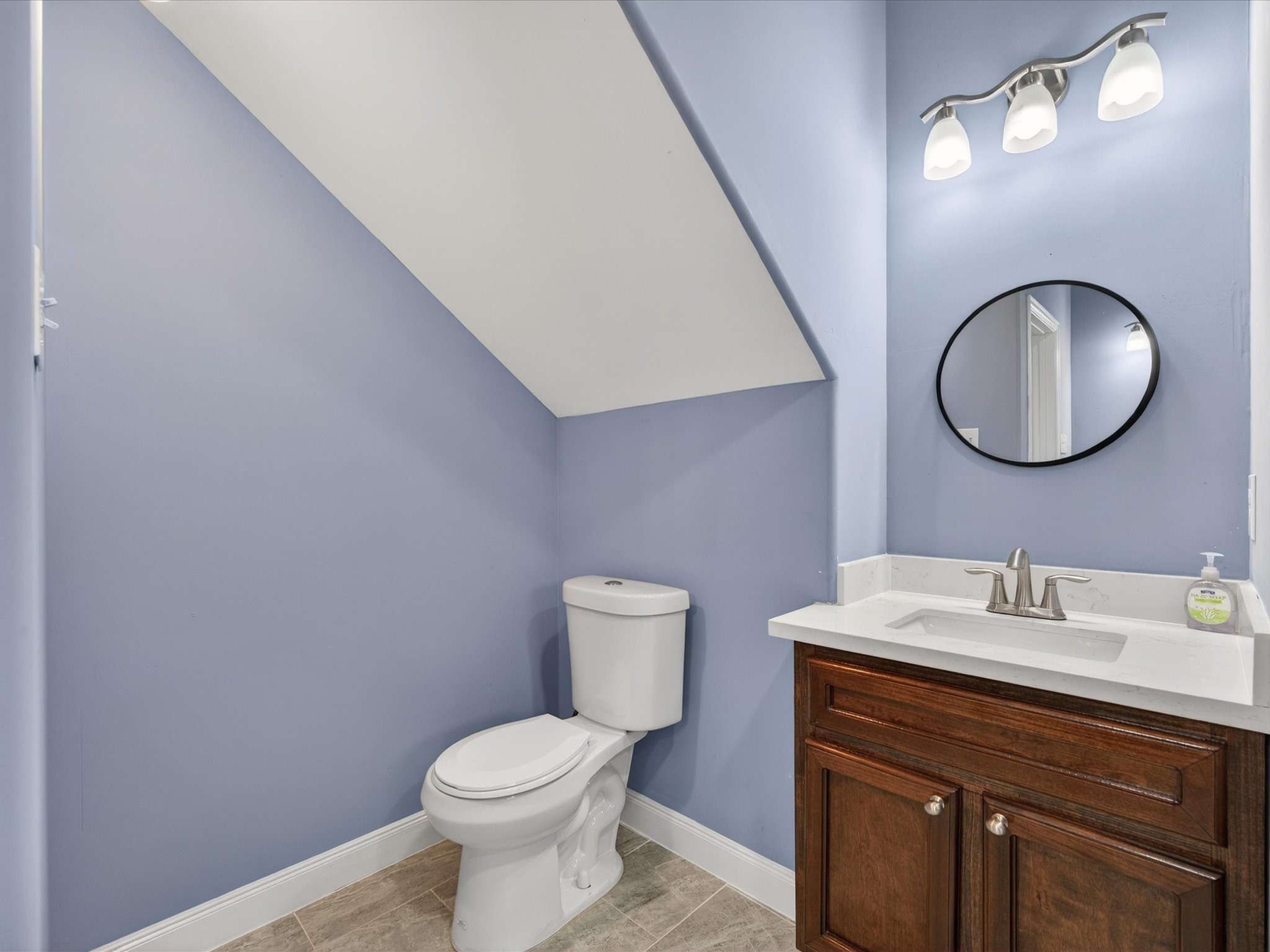 1833 County Road 3556 Cleveland, TX 77327 - Photo 15 of 30 a bathroom with a toilet sink vanity and mirror