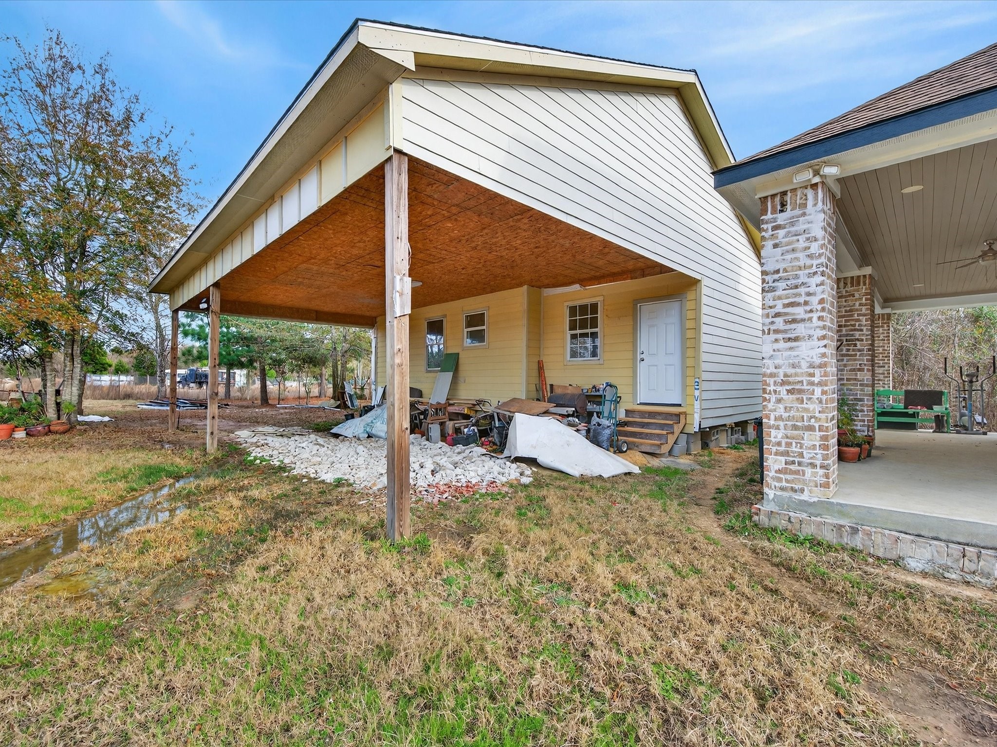 1833 County Road 3556 Cleveland, TX 77327 - Photo 24 of 30 a view of a house with backyard and sitting area