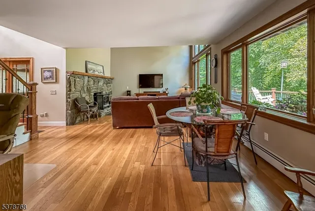 a view of a dining room with furniture window and wooden floor