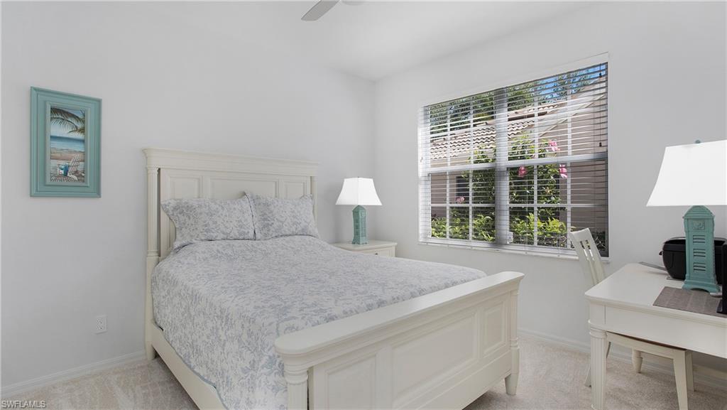 5705 Heron Lane, Unit 801 Naples, FL 34110 - Photo 13 of 32 a bed sitting in a bedroom next to a window