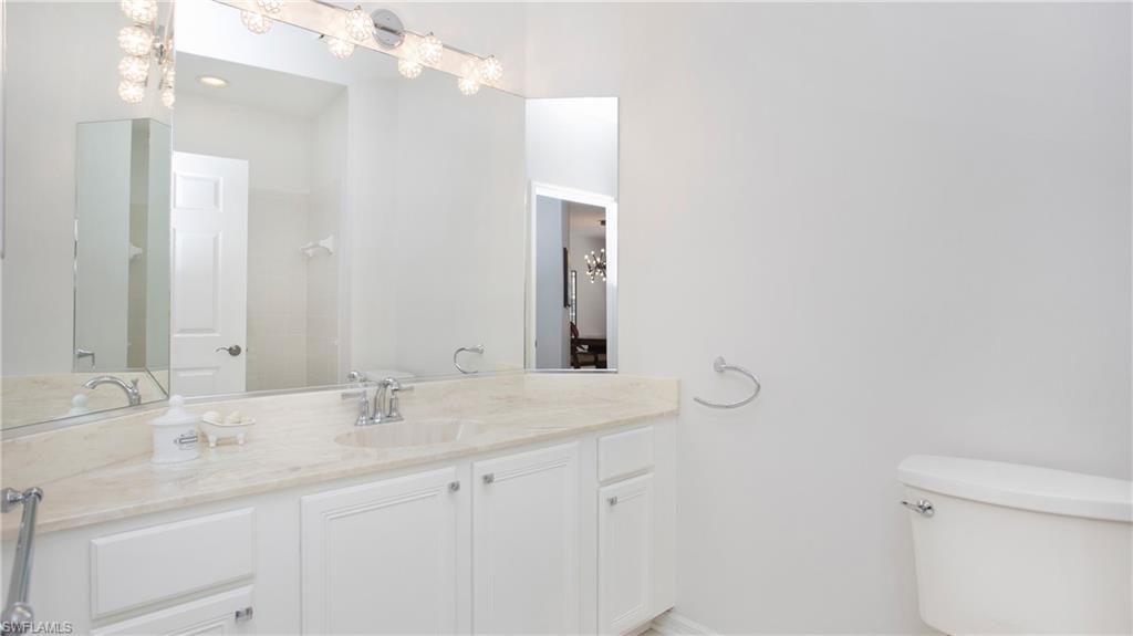5705 Heron Lane, Unit 801 Naples, FL 34110 - Photo 14 of 32 a bathroom with a sink vanity granite and toilet