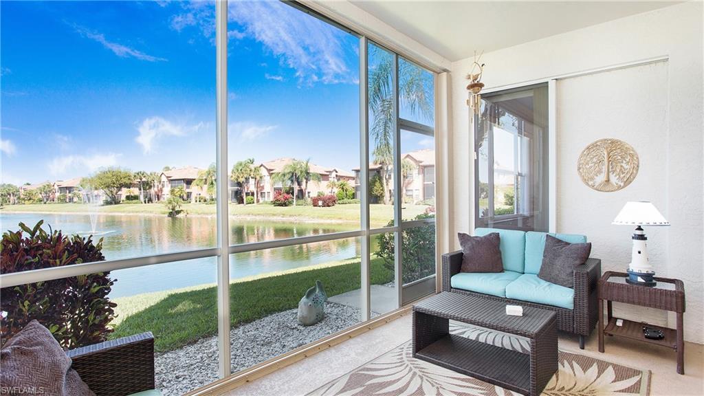 5705 Heron Lane, Unit 801 Naples, FL 34110 - Photo 17 of 32 a living room with furniture and a floor to ceiling window