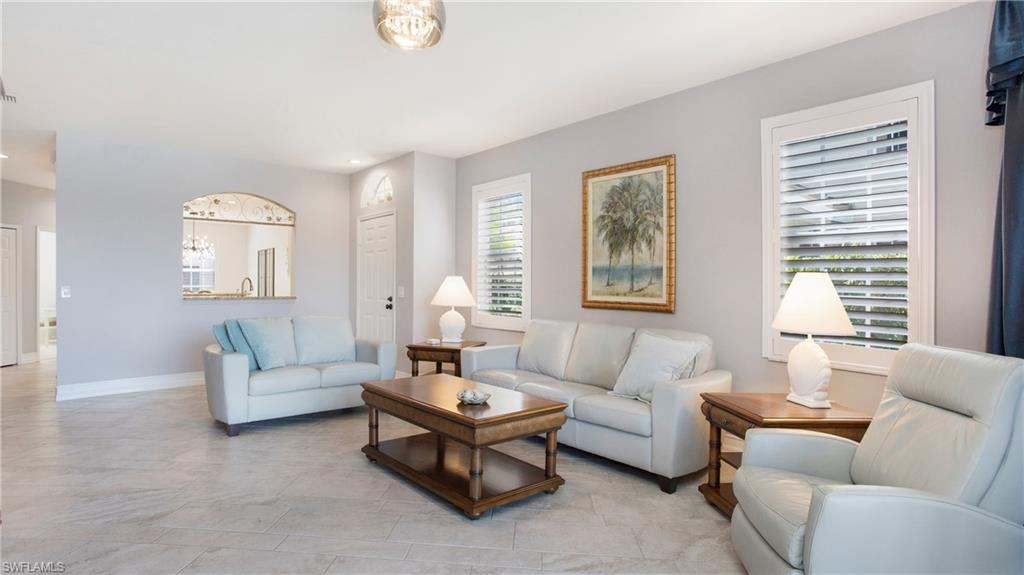 5705 Heron Lane, Unit 801 Naples, FL 34110 - Photo 5 of 32 a living room with furniture and a large window