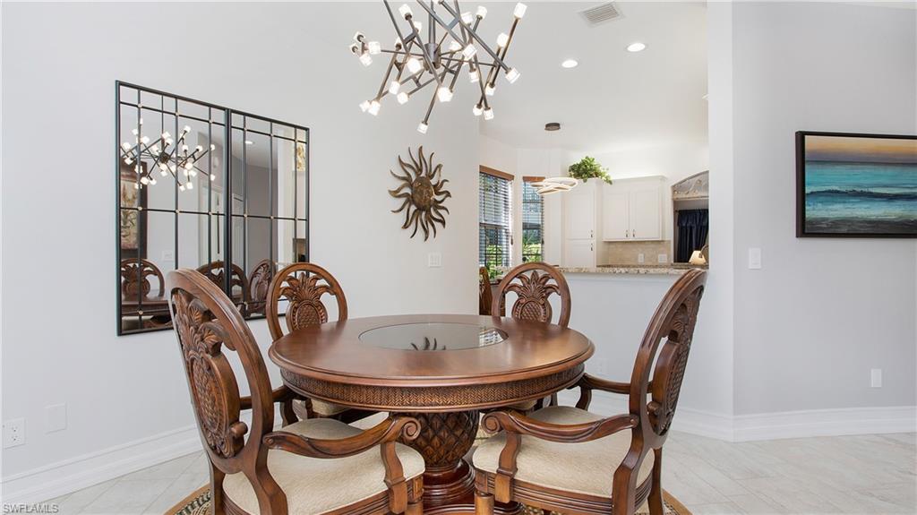5705 Heron Lane, Unit 801 Naples, FL 34110 - Photo 6 of 32 a view of a dining room with furniture and chandelier