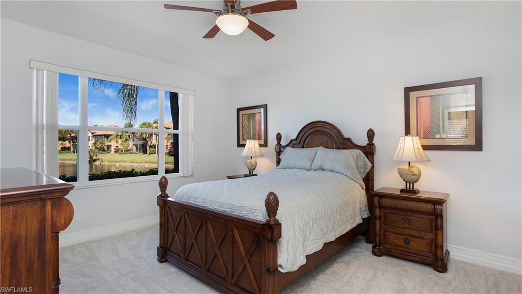 5705 Heron Lane, Unit 801 Naples, FL 34110 - Photo 10 of 32 a bedroom with a bed and a chandelier