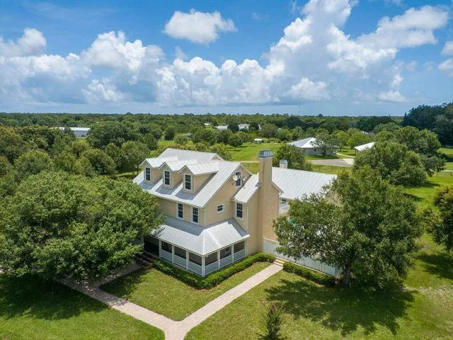 a view of a house with a yard and a garden