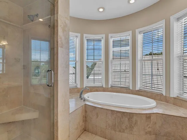 a bathroom with a tub and a shower