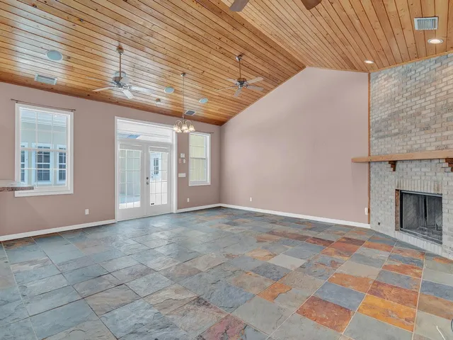 a view of empty room with a fireplace