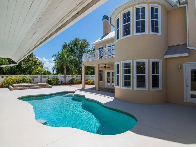 a view of an house with swimming pool and porch