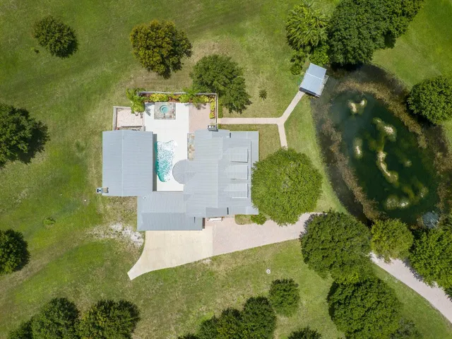 an aerial view of a house with a yard