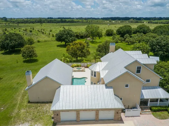 an aerial view of a house with a yard
