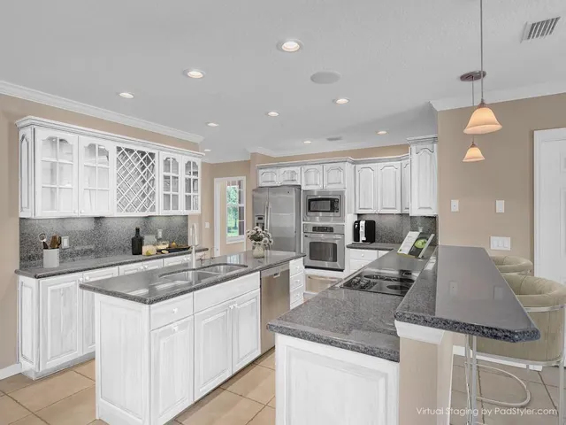 a kitchen with a sink stove and refrigerator