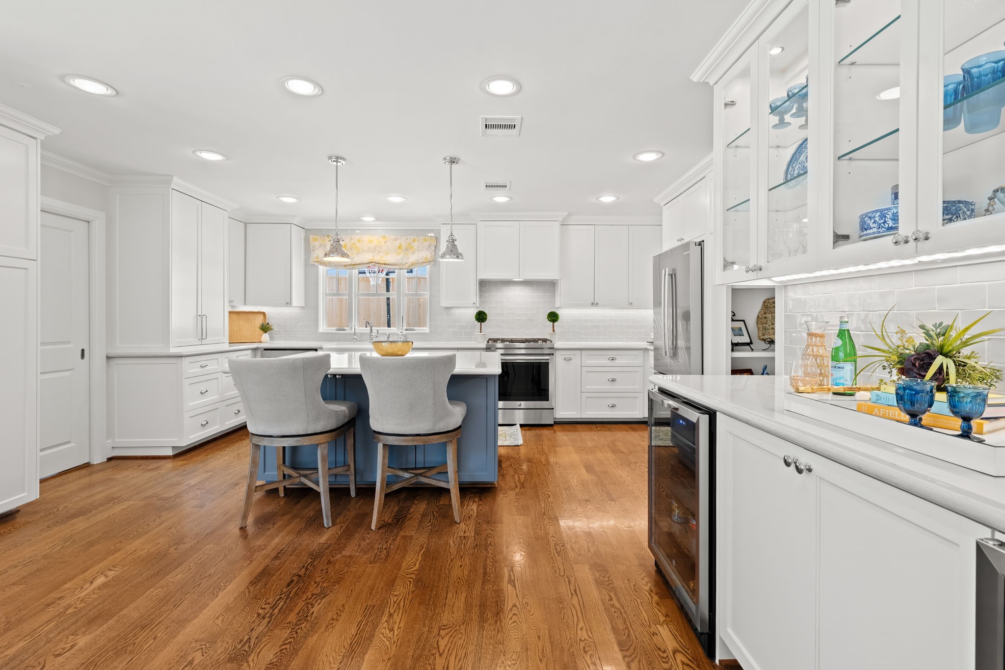 13614 Apple Tree Road Houston, TX 77079 - Photo 15 of 38 a large white kitchen with a table and chairs