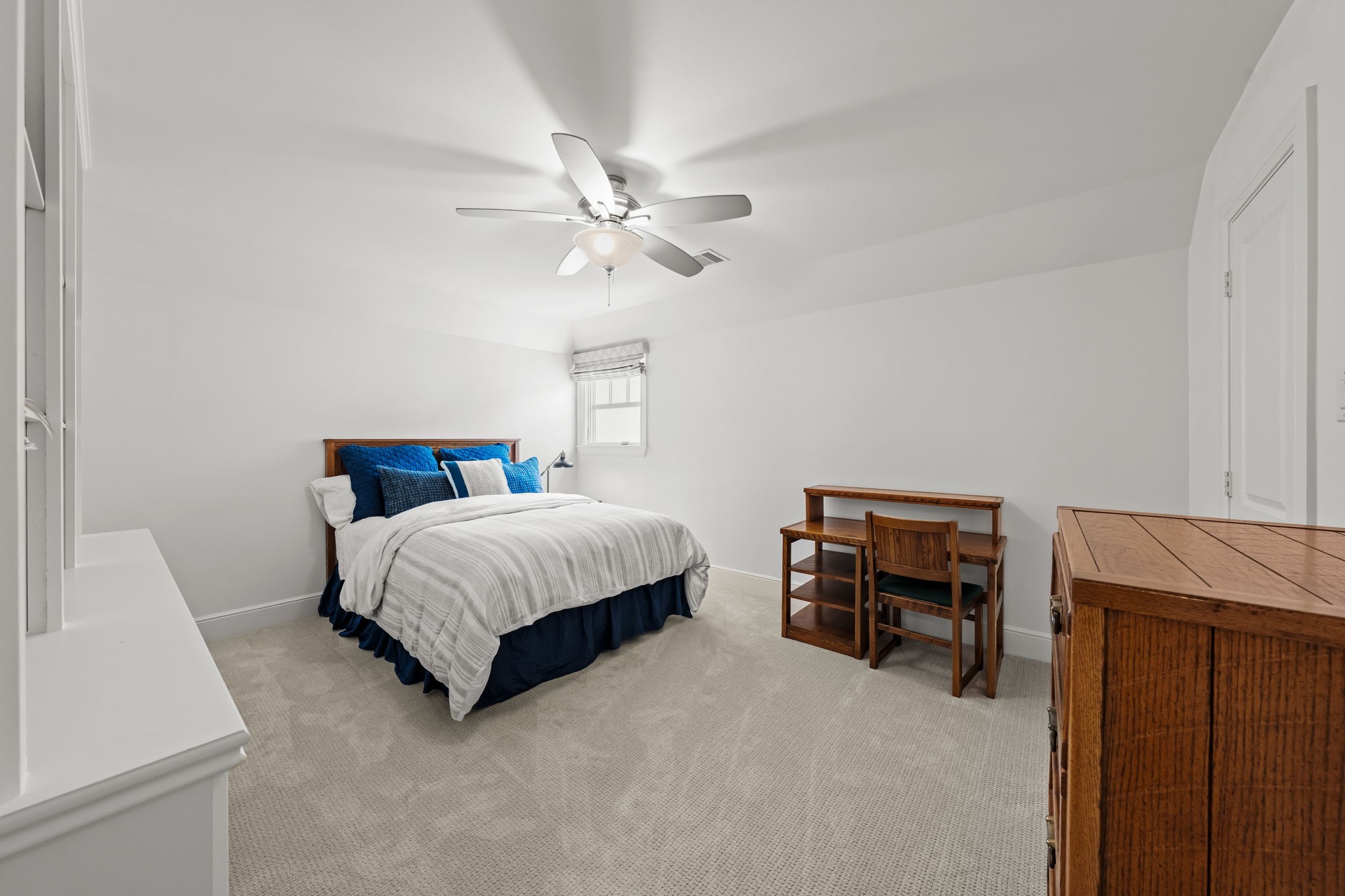 13614 Apple Tree Road Houston, TX 77079 - Photo 25 of 38 a bedroom with a bed and a chandelier