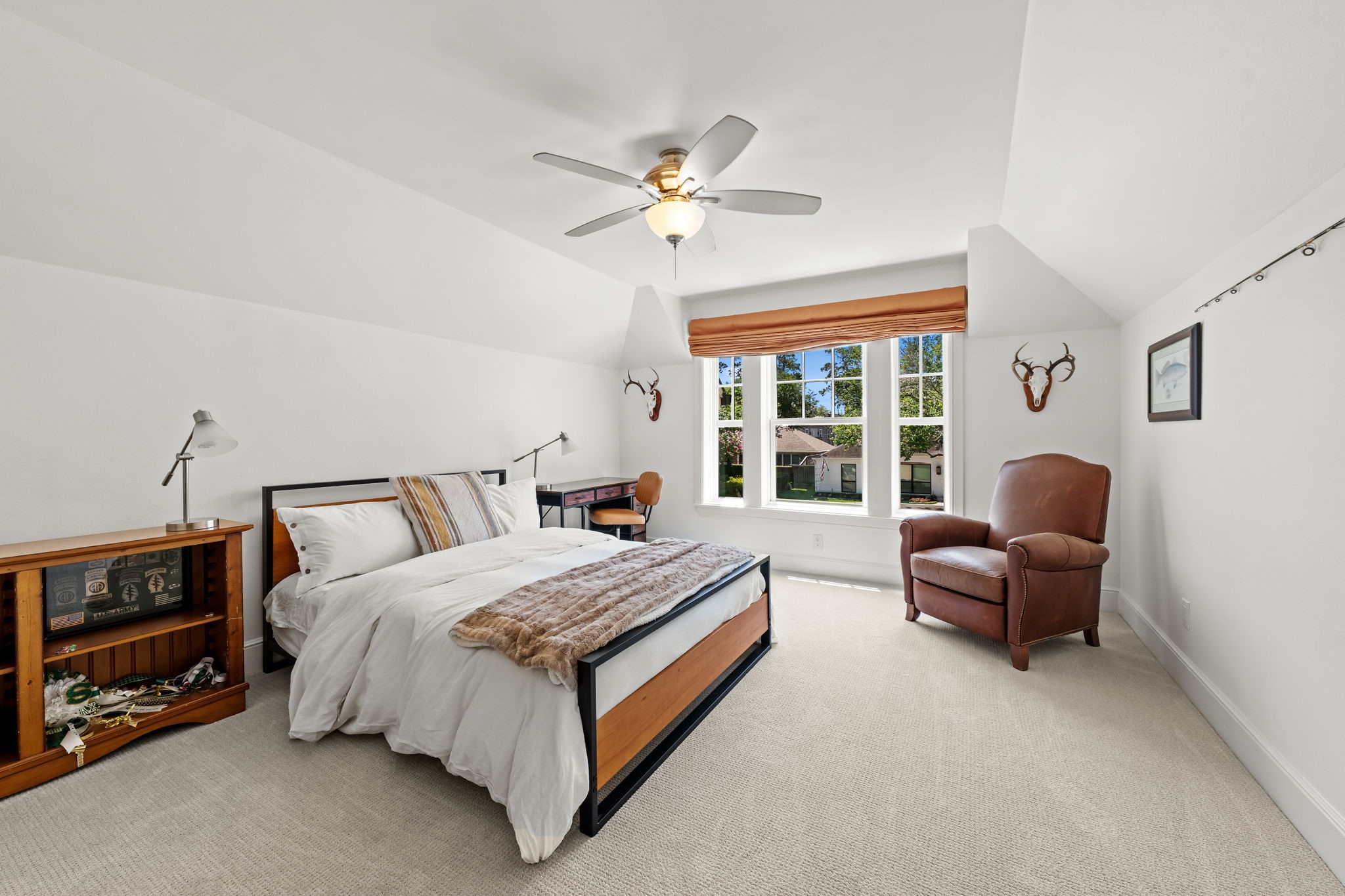 13614 Apple Tree Road Houston, TX 77079 - Photo 27 of 38 a spacious bedroom with a bed a couch and a chandelier