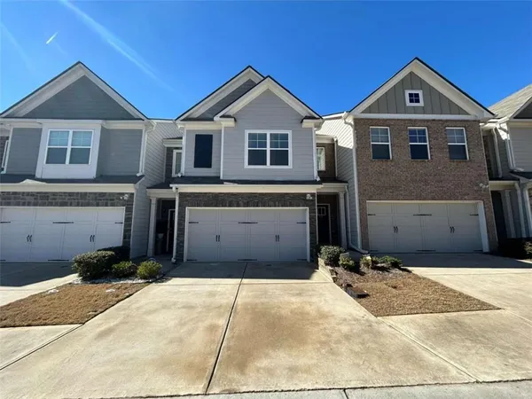 a front view of a house with a yard