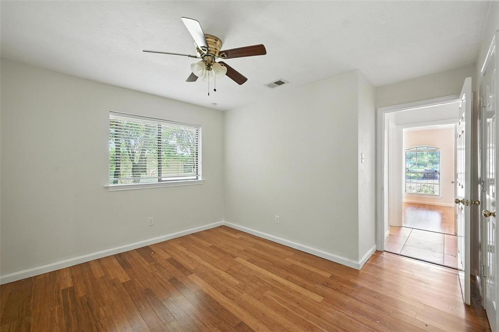 1928 Meandering Way McKinney, TX 75071 - Photo 11 of 22 an empty room with wooden floor fan and windows