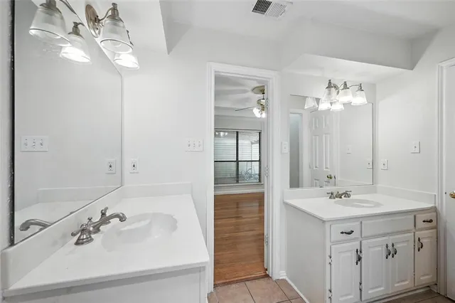 a bathroom with a sink double vanity and a mirror