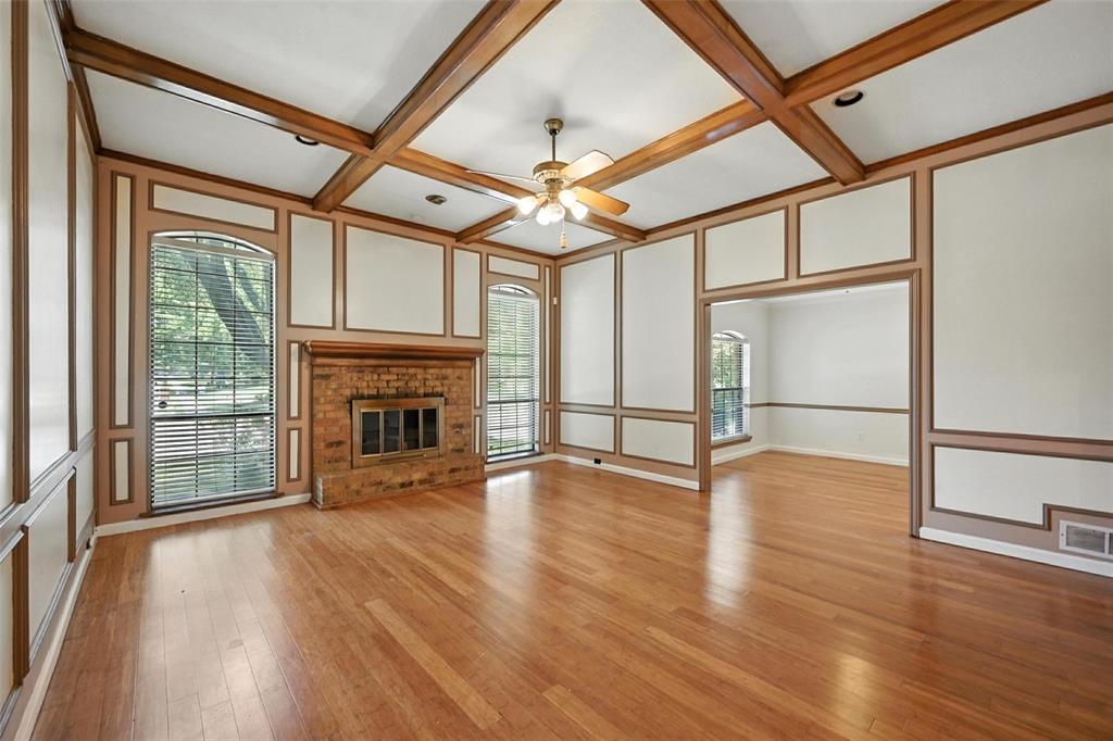 1928 Meandering Way McKinney, TX 75071 - Photo 3 of 22 a view of an empty room with wooden floor fireplace and a window