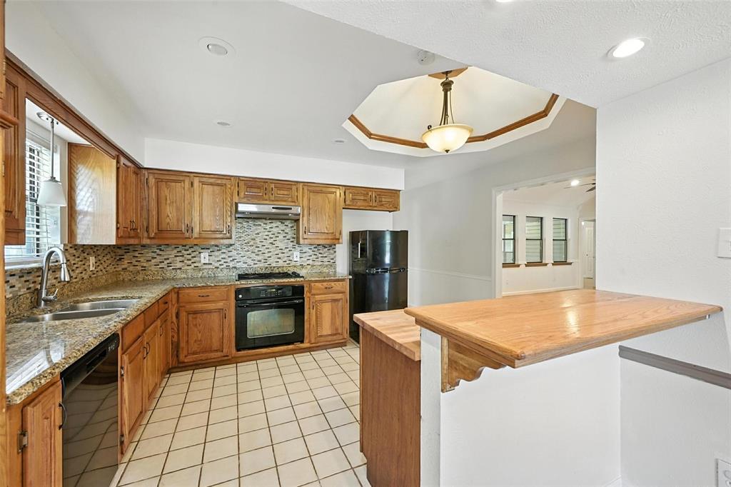 1928 Meandering Way McKinney, TX 75071 - Photo 5 of 22 a kitchen with a stove a sink and a microwave