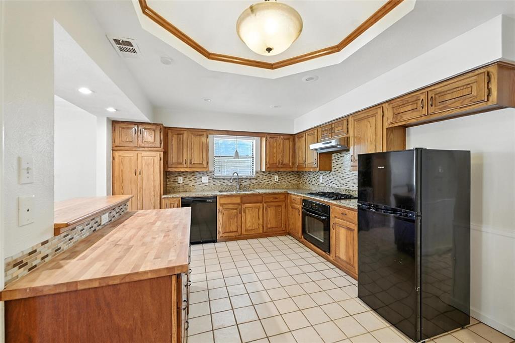 1928 Meandering Way McKinney, TX 75071 - Photo 6 of 22 a kitchen with stainless steel appliances granite countertop a refrigerator and a stove top oven
