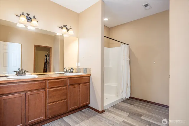 a bathroom with a double vanity sink and mirror