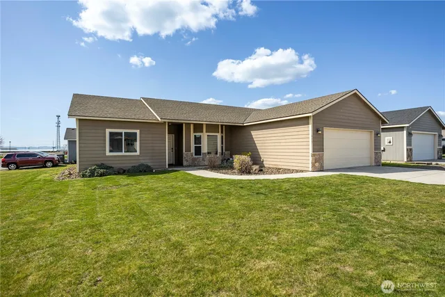 a front view of a house with a garden