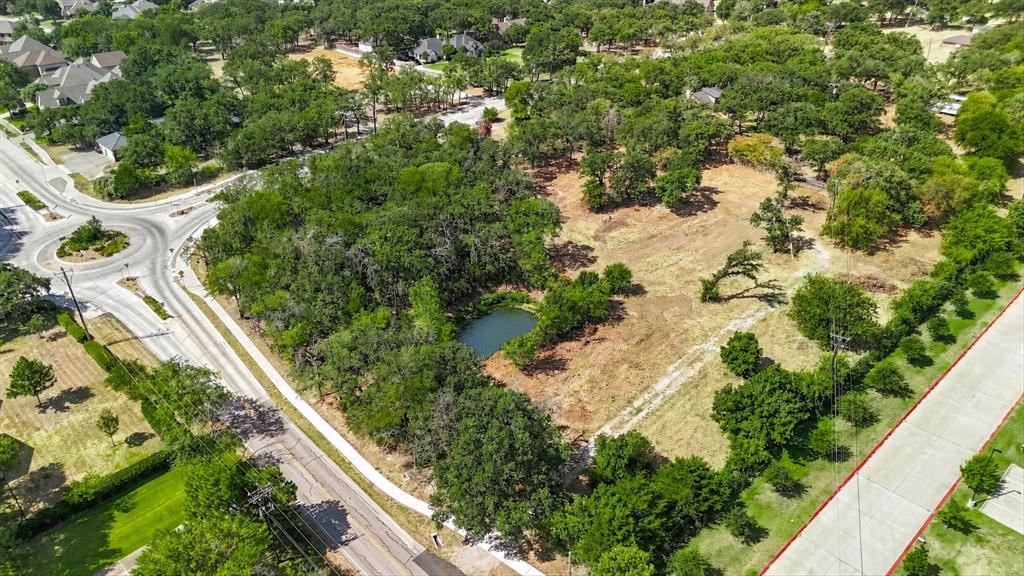 1347 Johnson Road Keller, TX 76248 - Photo 1 of 18 Expansive lot featuring mature trees, a natural pond, and direct access to a paved road and sidewalk