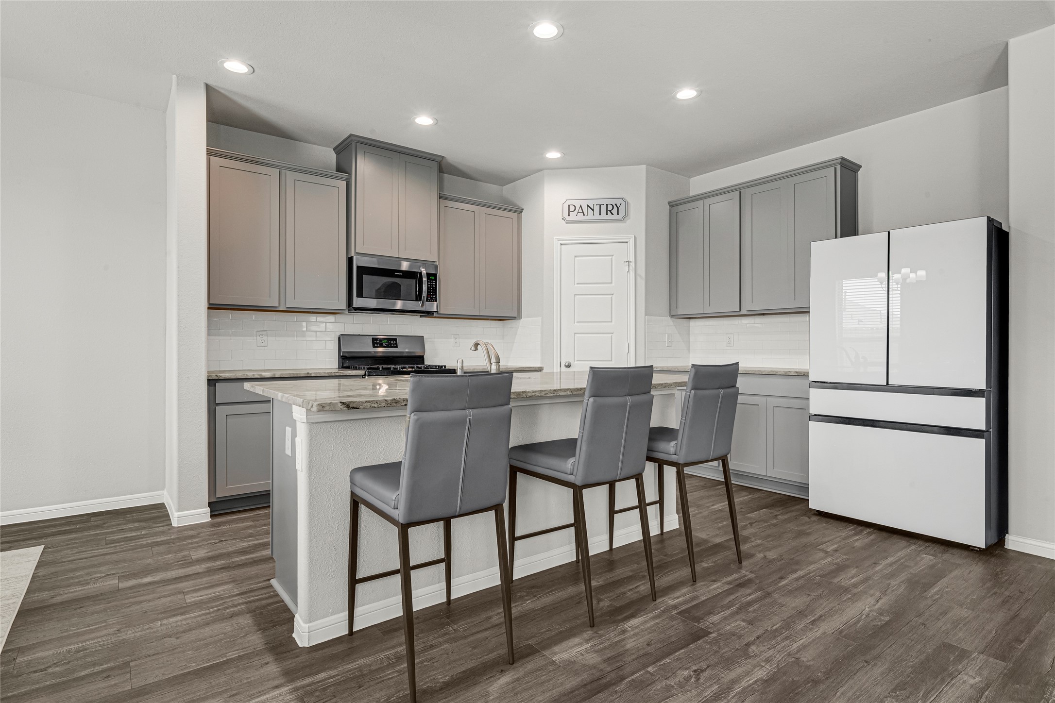 4206 Fenwick Road Texas City, TX 77591 - Photo 7 of 26 The kitchen with its beautiful quartz island and kitchen sink provides additional counter space for eating and entertainment.