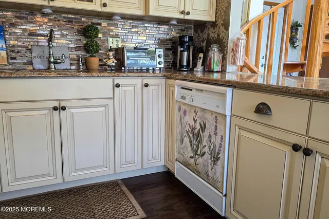 a kitchen with stainless steel appliances granite countertop lots of counter top space and wooden floor