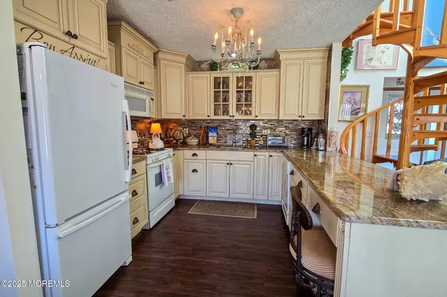 a view of a dining room with furniture and chandelier