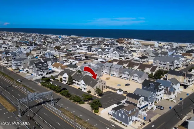 an aerial view of residential building and car parked