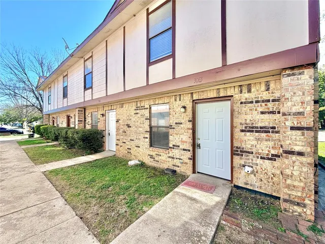 front view of a building with a yard