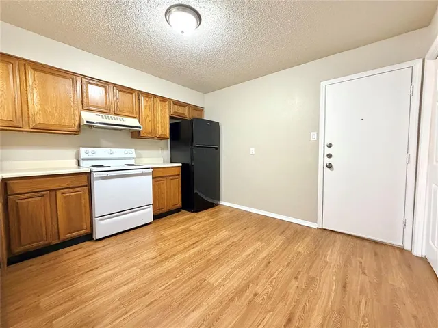 a kitchen with a stove a sink and a refrigerator