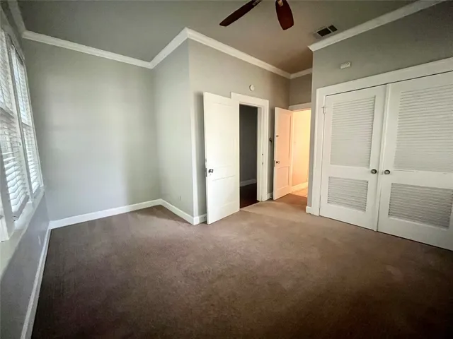 an empty room with windows and closet