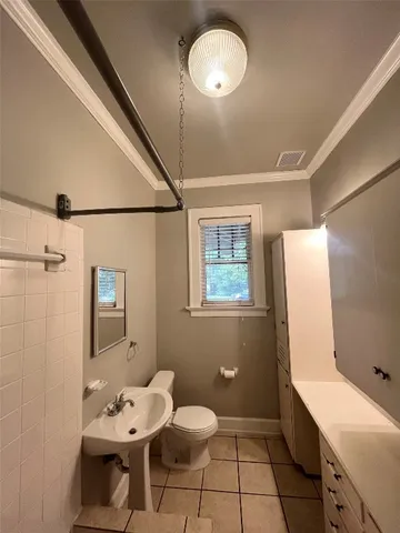 a bathroom with a sink mirror and a toilet