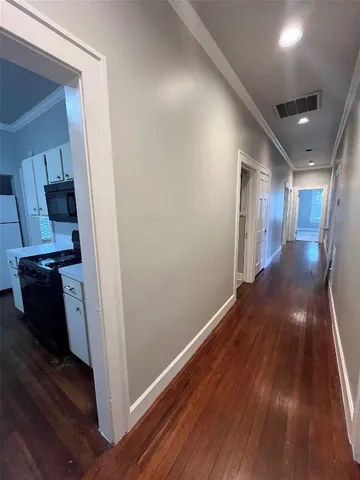 a view of hallway with wooden floor