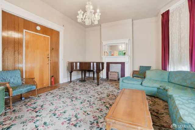 a living room with furniture and a chandelier