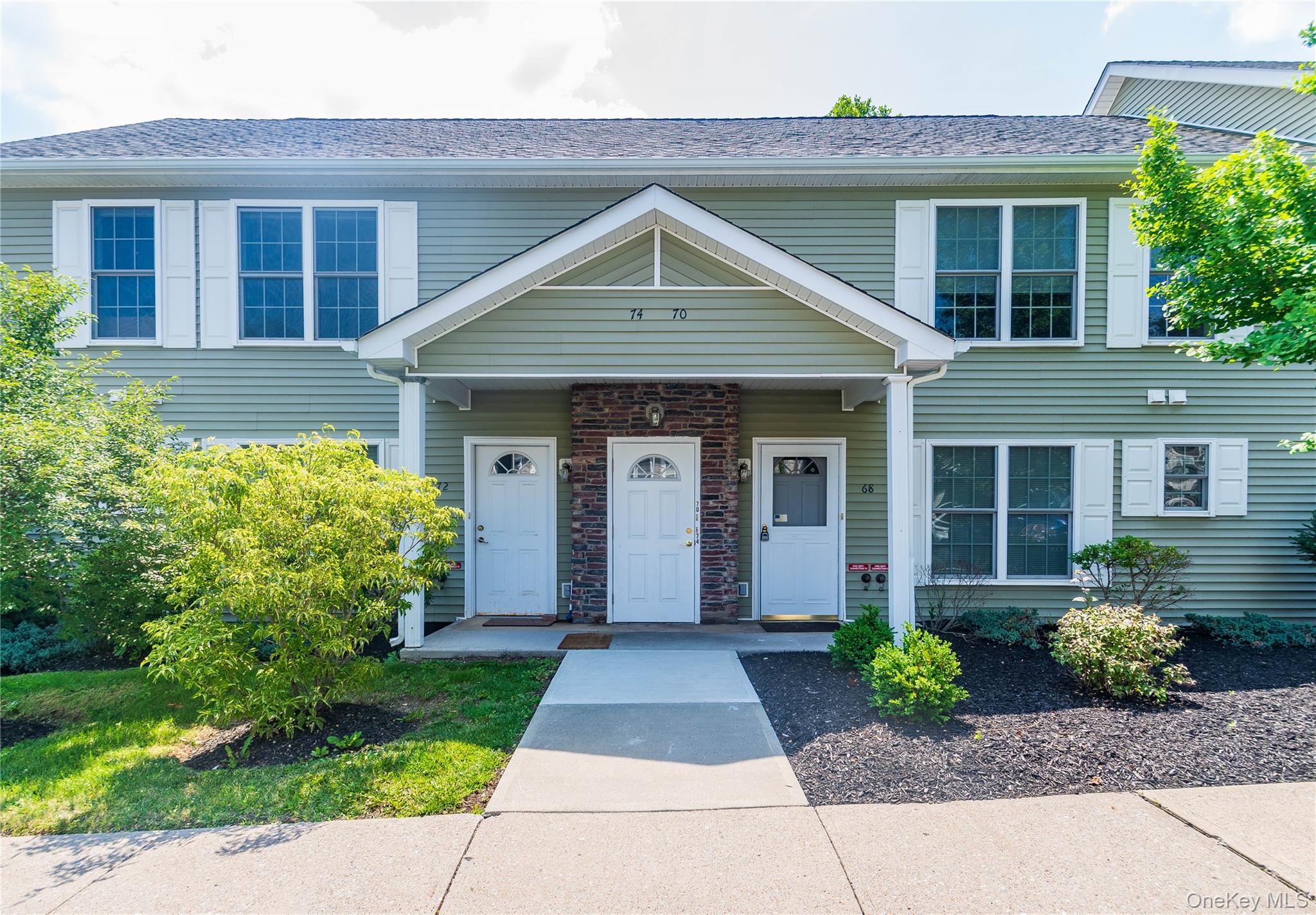 a front view of a house with garden
