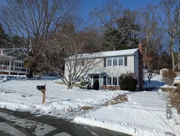 a view of a house with snow on the road