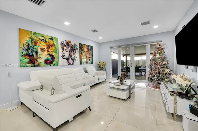 a living room with furniture and a flat screen tv