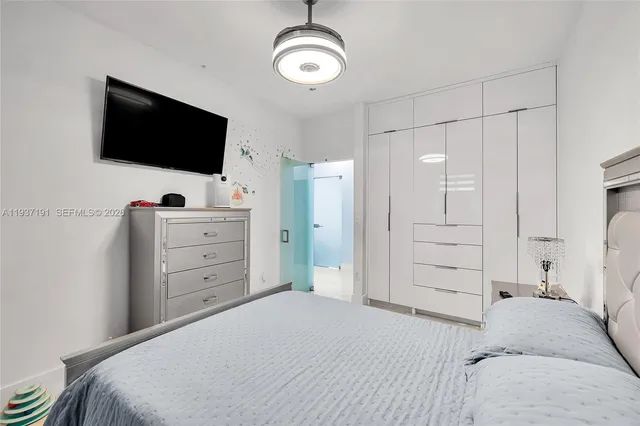 a bedroom with a bed and a chandelier