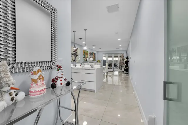 a kitchen with stainless steel appliances furniture and a living room