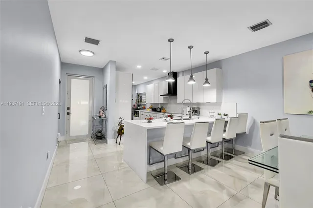 a large kitchen with a table and chairs