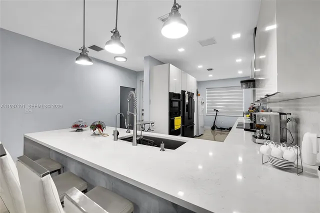 a view of a dining area with furniture and a chandelier