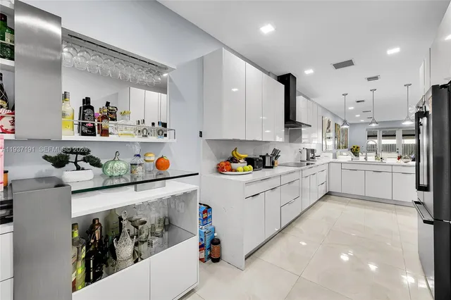 a kitchen with stainless steel appliances granite countertop a sink and cabinets