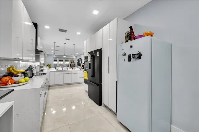 a kitchen with stainless steel appliances a refrigerator and a stove