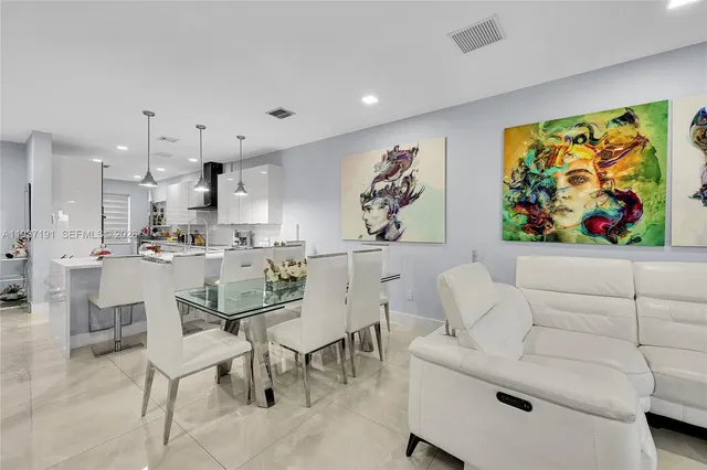 a living room with furniture and wall paintings