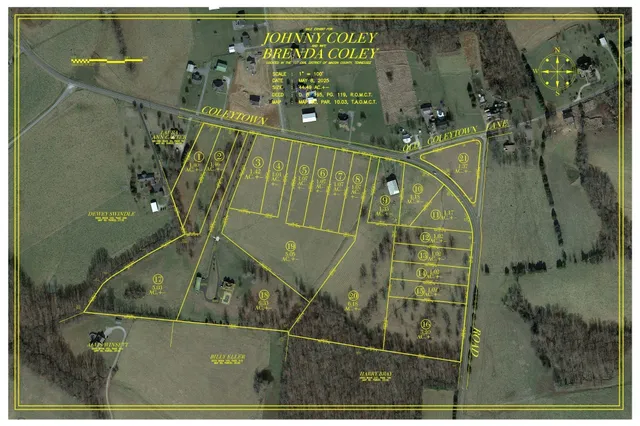 an aerial view of a residential houses with yard